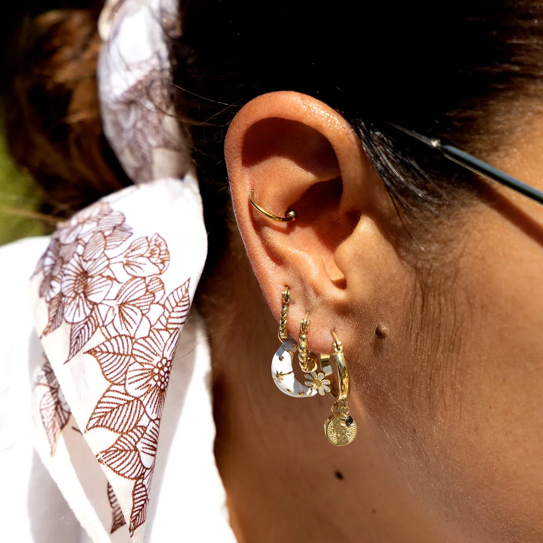 Gold coloured hoop earrings with a flower charm